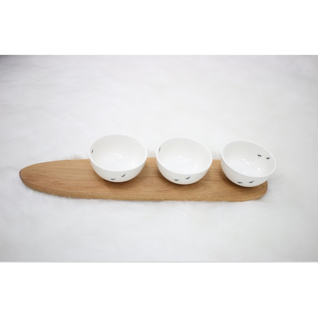 Three white ant snack bowls with wooden tray
