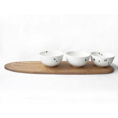 Three white snack bowls with bird print and wooden tray