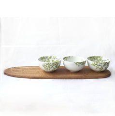 Three white tapas bowls with fern print and wooden tray