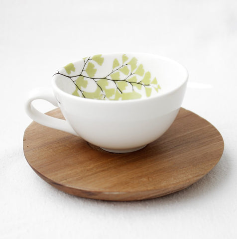 White espresso cup with fern design and wooden saucer 