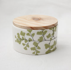 White storage jar with wooden lid