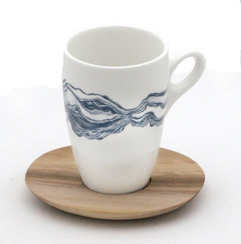 White coffee mug with blue mineral print and wooden saucer 