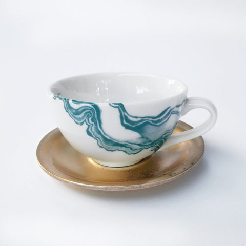 White espresso cup with teal mineral print and brass saucer 